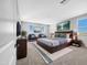 Spacious main bedroom with a large bed, seating area, and plenty of natural light at 5616 W Paseo Way, Laveen, AZ 85339