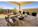 Inviting covered patio with stylish outdoor furniture and desert landscaping offers a relaxing space at 1417 E Cherrywood Pl, Chandler, AZ 85249