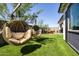 Lush backyard boasts a comfortable hanging chair and low-maintenance turf, perfect for relaxation and entertainment at 1417 E Cherrywood Pl, Chandler, AZ 85249