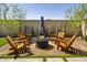 Beautifully landscaped backyard features a fire pit area with Adirondack chairs for outdoor enjoyment at 1417 E Cherrywood Pl, Chandler, AZ 85249