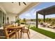 Outdoor patio featuring a dining table, lounge area with pergola, and pool with integrated water feature at 1427 E Cherrywood Pl, Chandler, AZ 85249