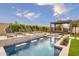 Backyard pool featuring lounge chairs, a waterfall feature, decorative tile, and pergola-covered seating at 1427 E Cherrywood Pl, Chandler, AZ 85249