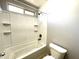 Bathroom with shower/tub combo and tiled walls at 17323 W Woodlands Ave, Goodyear, AZ 85338