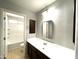 Bathroom with dark brown vanity and bathtub at 17323 W Woodlands Ave, Goodyear, AZ 85338