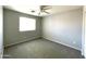 Bright bedroom featuring neutral walls and carpet at 17323 W Woodlands Ave, Goodyear, AZ 85338