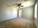 Bright bedroom with carpet flooring and ceiling fan at 17323 W Woodlands Ave, Goodyear, AZ 85338