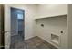 Convenient laundry room with built-in shelving at 17323 W Woodlands Ave, Goodyear, AZ 85338