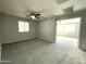 Large bedroom with carpet, ceiling fan and access to another room at 17323 W Woodlands Ave, Goodyear, AZ 85338