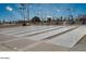 Multiple shuffleboard courts ready for play and surrounded by benches, and sunlit sky at 17200 W Bell Rd # 667, Surprise, AZ 85374