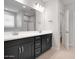 Modern bathroom with dual sinks, granite countertops, and stylish dark cabinets at 4107 E Ghost Flower Ln, San Tan Valley, AZ 85140