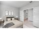 Neutral bedroom boasts a comfortable bed, artwork, and an ensuite bathroom at 4107 E Ghost Flower Ln, San Tan Valley, AZ 85140