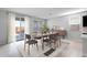 Bright dining area with sliding glass doors, stylish furniture, and a modern sideboard at 4107 E Ghost Flower Ln, San Tan Valley, AZ 85140