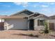 Charming single-story home with a brick driveway, two-car garage, and stylish stone accents at 4107 E Ghost Flower Ln, San Tan Valley, AZ 85140