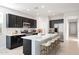 Modern kitchen boasts stainless steel appliances, quartz countertops, and a large center island with barstool seating at 4107 E Ghost Flower Ln, San Tan Valley, AZ 85140