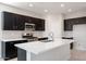 Well-lit kitchen featuring a large island, stainless steel appliances, and stylish cabinetry at 4107 E Ghost Flower Ln, San Tan Valley, AZ 85140