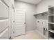 The laundry room features shelving and neutral tile floors at 4107 E Ghost Flower Ln, San Tan Valley, AZ 85140