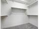 A clean walk-in closet with installed shelving and grey carpeting at 4107 E Ghost Flower Ln, San Tan Valley, AZ 85140