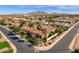 An aerial view showcases the tile roof, mature palms and circular drive of this well maintained home at 4301 E Taurus Pl, Chandler, AZ 85249