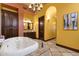 Luxurious bathroom featuring a standalone soaking tub and elegant chandelier lighting at 4301 E Taurus Pl, Chandler, AZ 85249