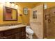 Bathroom featuring a brown vanity, granite countertop, and tiled walk-in shower at 4301 E Taurus Pl, Chandler, AZ 85249