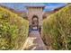 Lush, verdant courtyard entrance with wrought iron gate at 4301 E Taurus Pl, Chandler, AZ 85249