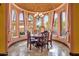 Elegant dining room with a round table, ornate chairs, and a chandelier beneath a domed ceiling at 4301 E Taurus Pl, Chandler, AZ 85249