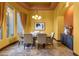 Elegant dining room features travertine floors, a stylish chandelier, and views of the lush backyard at 4301 E Taurus Pl, Chandler, AZ 85249