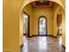 Bright foyer boasts elegant tile flooring, decorative wrought iron door and arched doorway, with stylish design at 4301 E Taurus Pl, Chandler, AZ 85249