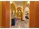 Arched hallway with tile flooring and decorative sconces at 4301 E Taurus Pl, Chandler, AZ 85249