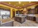 Well-equipped kitchen featuring dark wood cabinets, granite countertops, a center island, and stainless steel appliances at 4301 E Taurus Pl, Chandler, AZ 85249