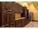 Mudroom featuring built-in cabinets, granite countertops, drawers, and a stainless steel refrigerator at 4301 E Taurus Pl, Chandler, AZ 85249