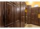 Custom pantry featuring dark wood cabinets, wine racks, and ample storage space in a well-organized layout at 4301 E Taurus Pl, Chandler, AZ 85249