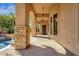 Covered outdoor patio featuring stone pillars, ceiling fans, and tiled floor at 4301 E Taurus Pl, Chandler, AZ 85249