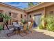 Outdoor patio with fireplace, dining table and desert landscaping at 4301 E Taurus Pl, Chandler, AZ 85249