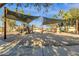 Community playground with modern play structures and shade canopies set in a sand base at 4301 E Taurus Pl, Chandler, AZ 85249