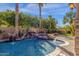 Pool area with a spa, waterfall, and lush greenery at 4301 E Taurus Pl, Chandler, AZ 85249