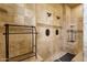 Large walk-in shower with dual shower heads and travertine tile surround at 4301 E Taurus Pl, Chandler, AZ 85249