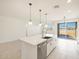 Modern kitchen island with stainless steel appliances and white cabinetry at 17738 W Coolidge St, Goodyear, AZ 85395