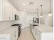 Modern kitchen island with white cabinets and stainless steel appliances at 17738 W Coolidge St, Goodyear, AZ 85395