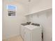 Laundry room with washer, dryer, and overhead shelving at 17738 W Coolidge St, Goodyear, AZ 85395