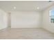 Bright and spacious living room with large windows and tile flooring at 17738 W Coolidge St, Goodyear, AZ 85395