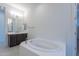 Relaxing bathroom with soaking tub and modern vanity at 19026 W Ocotillo Rd, Waddell, AZ 85355