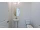 Modern powder room with pedestal sink and toilet at 19026 W Ocotillo Rd, Waddell, AZ 85355