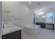 Modern bathroom with soaking tub and double vanity at 19026 W Ocotillo Rd, Waddell, AZ 85355