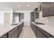 Modern kitchen with stainless steel appliances and herringbone backsplash at 19026 W Ocotillo Rd, Waddell, AZ 85355