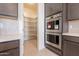 Walk-in pantry with ample shelving for food storage at 19026 W Ocotillo Rd, Waddell, AZ 85355