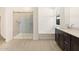 Bright bathroom featuring a glass enclosed shower, soaking tub, and dark wood vanity with white countertop at 25975 N 160Th Ln, Surprise, AZ 85387