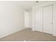 Bedroom with carpet and white trim features a sliding door closet at 25975 N 160Th Ln, Surprise, AZ 85387