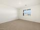 This bright bedroom has a large window and neutral carpet, providing a blank slate for personalization at 25975 N 160Th Ln, Surprise, AZ 85387