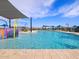 Sparkling community pool with fun splash features, shaded seating, and a clear blue sky at 25975 N 160Th Ln, Surprise, AZ 85387